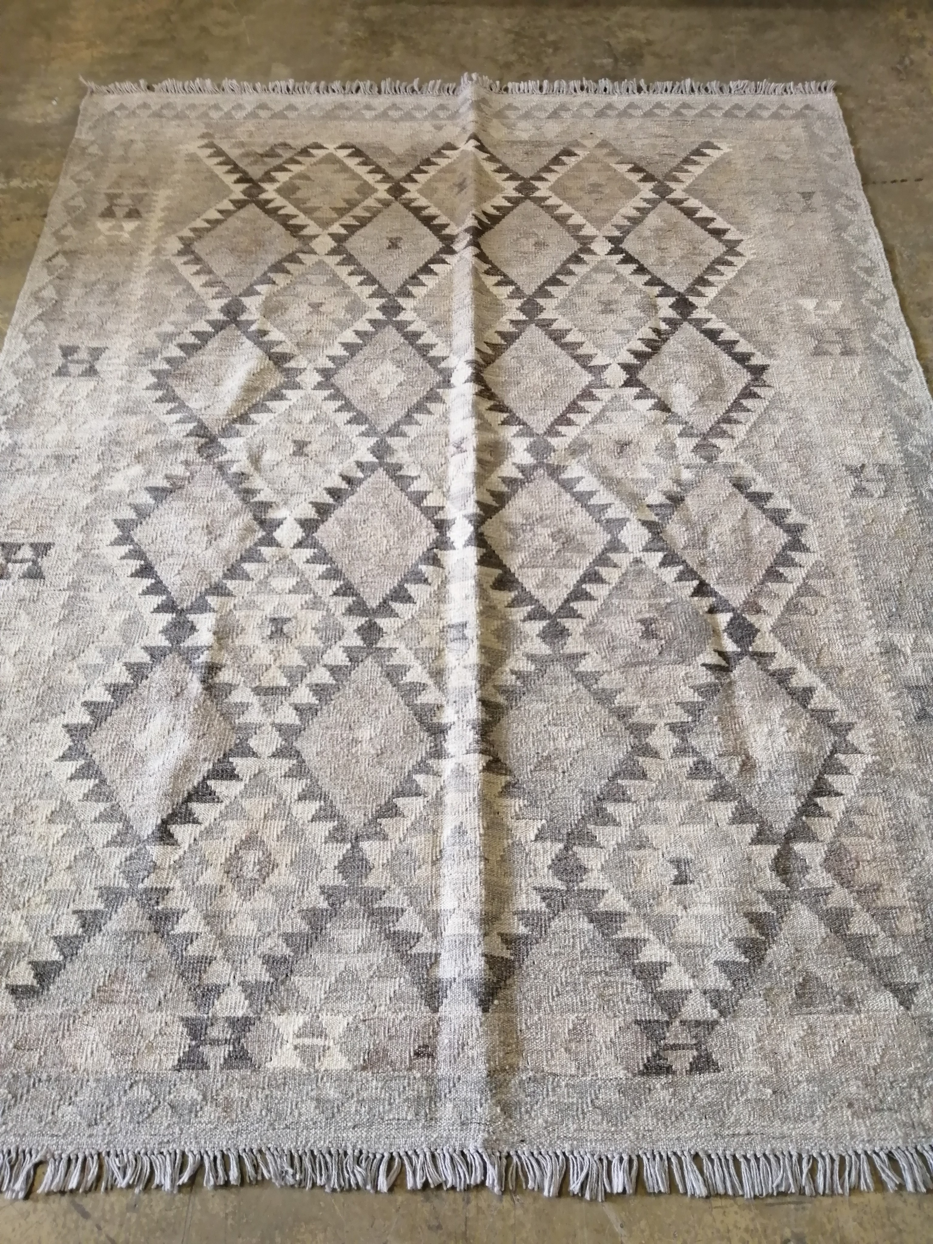 An Anatolian style monochrome Kilim carpet, 207 x 180cm